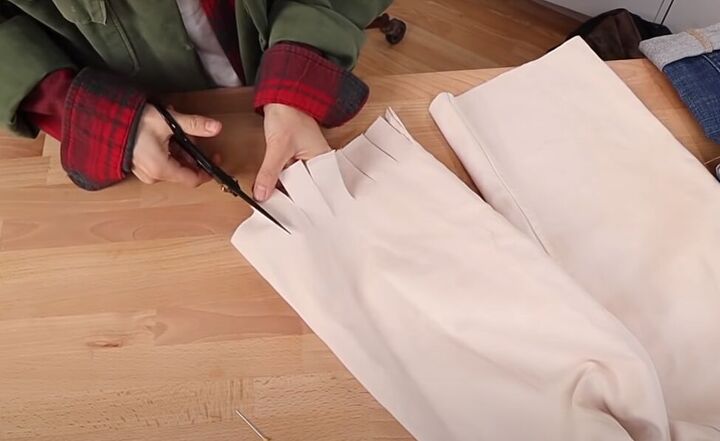 how to fray jeans in 7 different ways distress crop fray more, Cutting tabs on the bottom