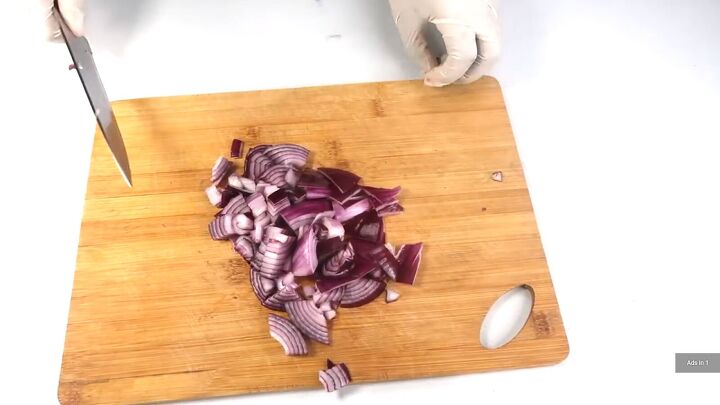 how to make a diy onion juice that promotes hair growth, Cutting up a red onion
