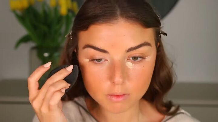 how to apply faux freckles for a sun kissed summer makeup look, Applying concealer to the corners of the eyes