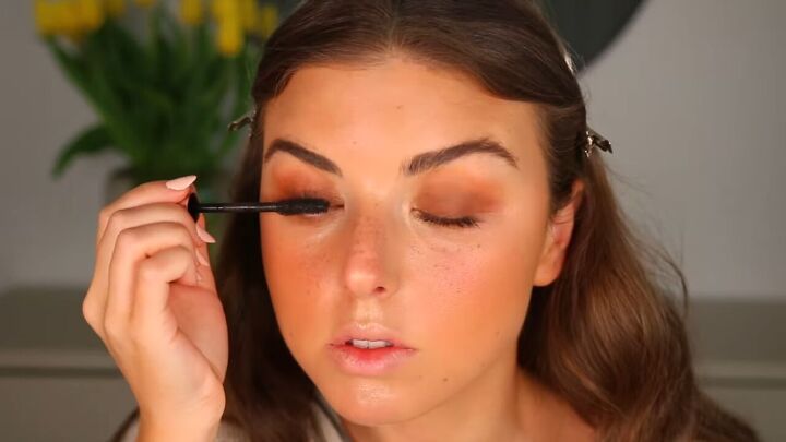 how to apply faux freckles for a sun kissed summer makeup look, Applying mascara to lashes