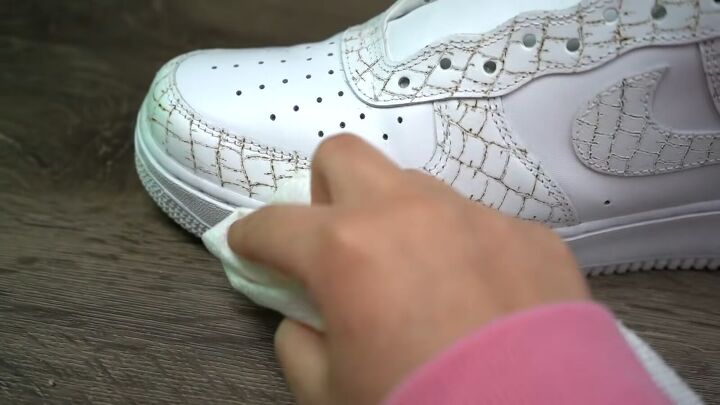 how to make textured diy croc skin sneakers with a wood burning tool, Rubbing off the debris