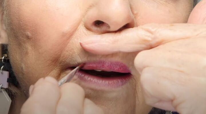 how to do luscious lip makeup for older women, Applying lipstick with a small makeup brush
