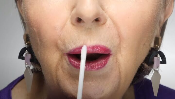 how to do luscious lip makeup for older women, Applying lip gloss over the lipstick