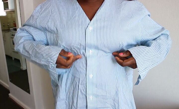 how to make a cute diy peplum top out of an old men s shirt, Trying on the shirt to determine the size