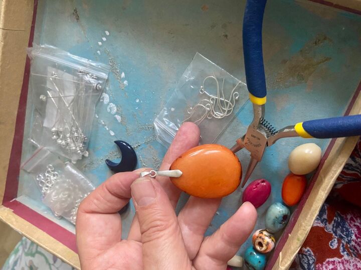 how to create a boho eco pendant from tagua nut, Squeeze bail into hole
