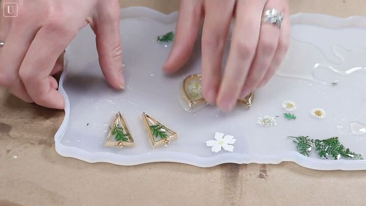 grab 2 plastic containers and make these gorgeous resin earrings, Leaving earrings to harden overnight