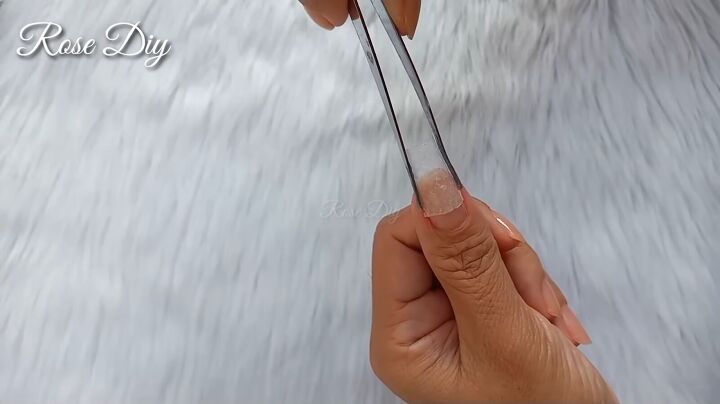 how to make fake nails with toilet paper baby powder, Holding the nail in place with tweezers