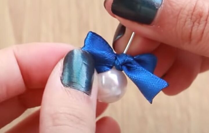 how to make dainty diy pearl bow earrings using a dinner fork, Using a headpin to pierce the bow