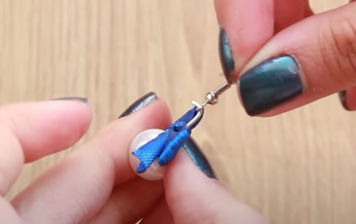 how to make dainty diy pearl bow earrings using a dinner fork, Inserting the loop into the earing wire
