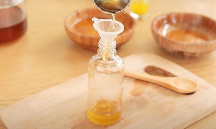 the 3 best ways to use honey for clear healthy glowing skin, Pouring the honey and oil mask into a small bottle