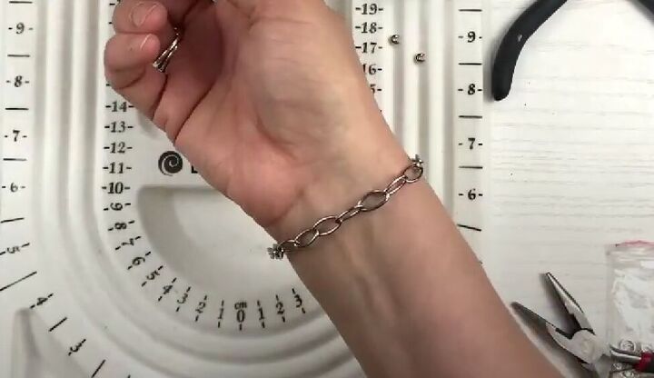 how to use old necklaces to make a pretty diy pearl chain bracelet, Measuring the chain around the wrist