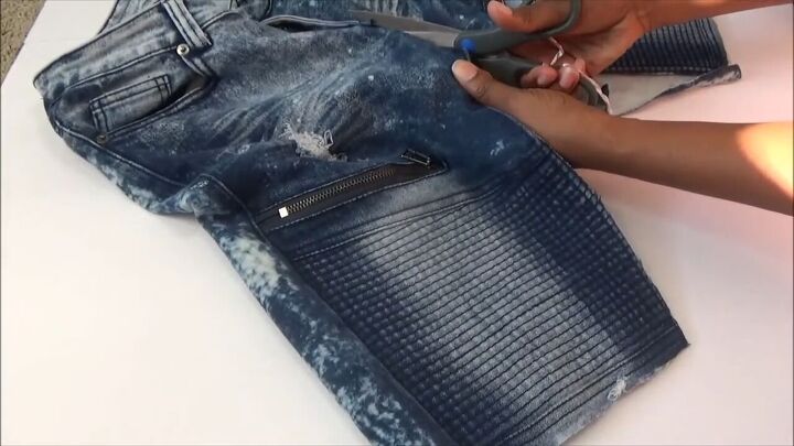 how to quickly turn your old distressed jeans into a stylish skirt, Cutting up the center of the jeans to the zipper