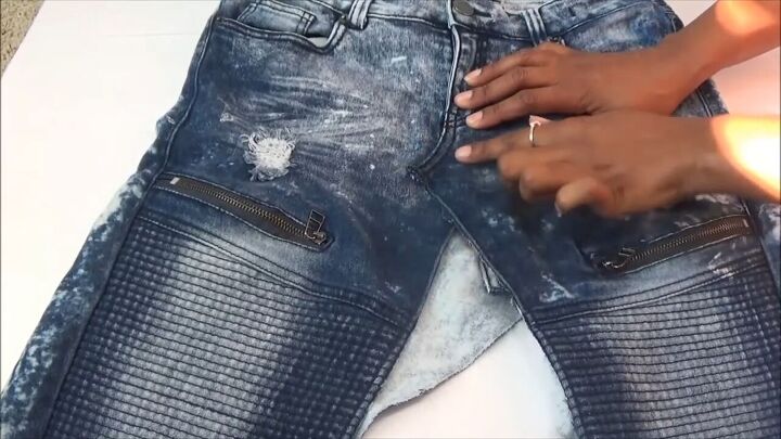 how to quickly turn your old distressed jeans into a stylish skirt, Folding one side of the center seam over the other