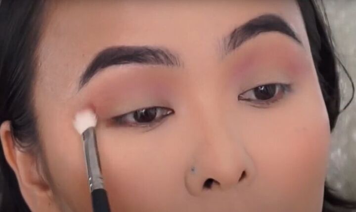 how to do a rose gold eyeshadow look with a metallic halo, Applying a light pink shade of eyeshadow as a base