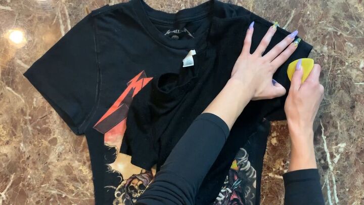 how to make a diy o ring crop top out of a band t shirt, Cutting the sleeves