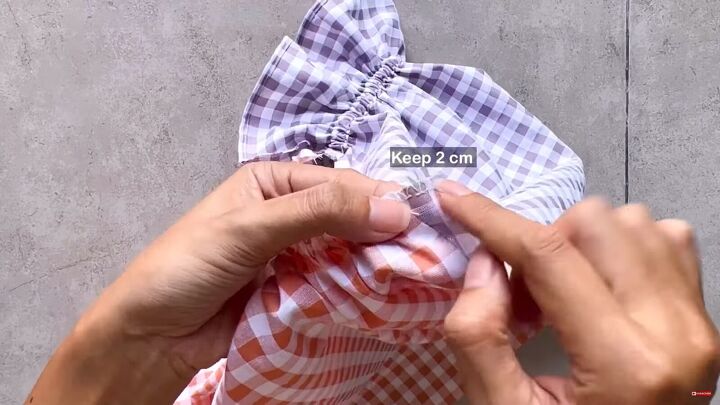 how to make a cute diy patchwork dress out of gingham scraps, Pinning the side piece to the sleeve s end