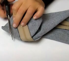 how to make a cute handmade makeup bag out of old denim, Cutting off the point of the triangle