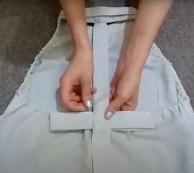 how to easily turn t shirts shirts into trendy tops, Pinning the bow to the back