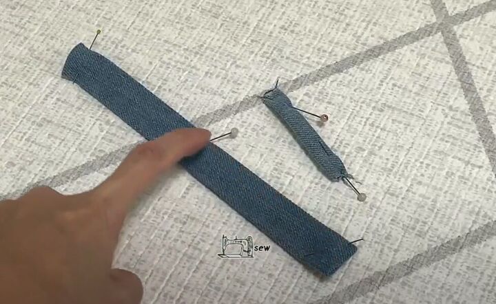 how to make a cute diy denim clutch bag out of an old jean dress, Making the strap and loop