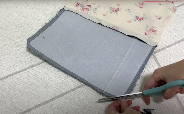 how to make a cute diy denim clutch bag out of an old jean dress, Snipping the corners
