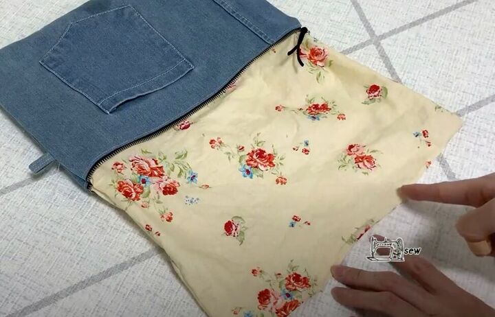 how to make a cute diy denim clutch bag out of an old jean dress, Turning the bag rights sides out