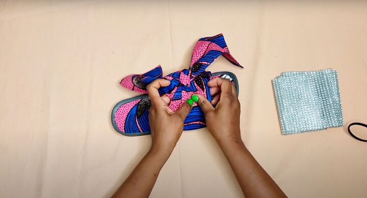 how to make cute diy slide sandals with african ankara fabric bows, Securing the bow with hot glue