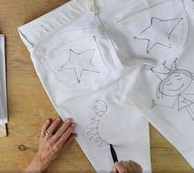 learn how to refashion old white jeans into fun and trendy pants, Doodling with black marker on the back of jeans