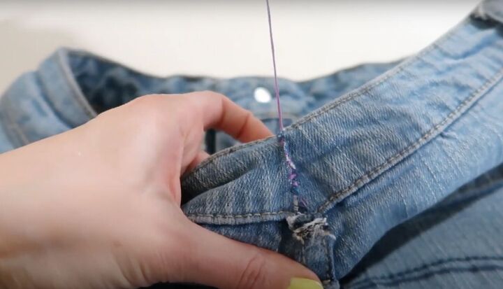 7 smart sewing hacks for beginners how to fix clothes with style, Pulling the threads to take in the jeans