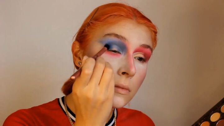 how to do a fun mad hatter makeup look for halloween, Applying blue eyeshadow on the other eye