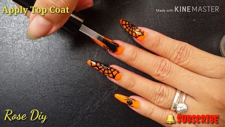 how to do fun spider web nail designs for halloween, Applying a top coat to the spider web nail design