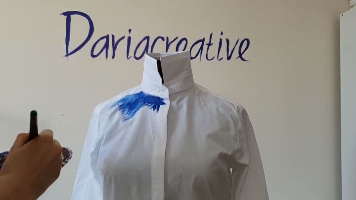 how to make a colorful rainbow inspired diy dripping paint shirt, Painting blue fabric paint around the shirt neck