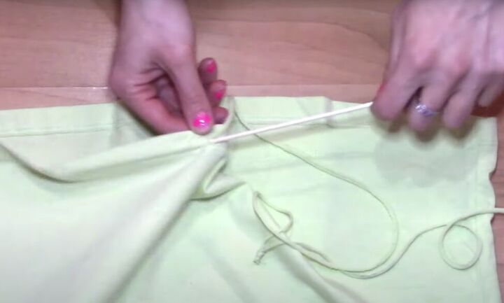 how to transform a t shirt into a drawstring skirt, Using a skewer to insert drawstring