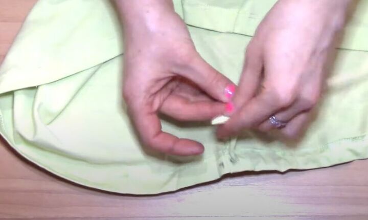 how to transform a t shirt into a drawstring skirt, Pulling drawstring out of hole
