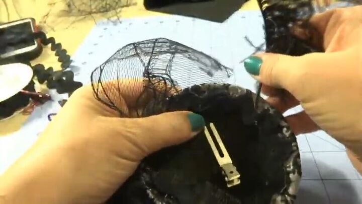 how to create an elegant halloween fascinator, Stabbing feather top between the lining and hat