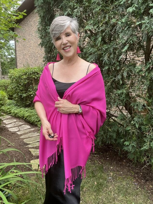 how to wear a slip dress seven different ways, I am wearing a black slip dress with a pink pashmina wrap and pink fringed earrings My shoes are nude pumps