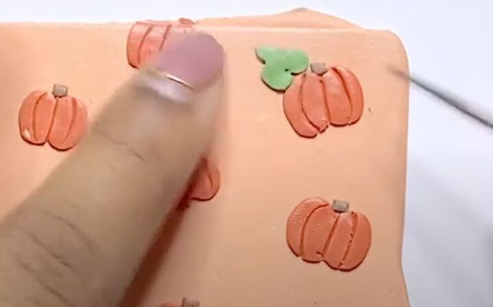 adorable polymer clay pumpkin earrings tutorial, Adding clay leaves