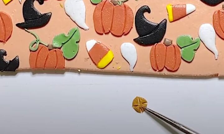 adorable polymer clay pumpkin earrings tutorial, Adding tiny clay flowers to design