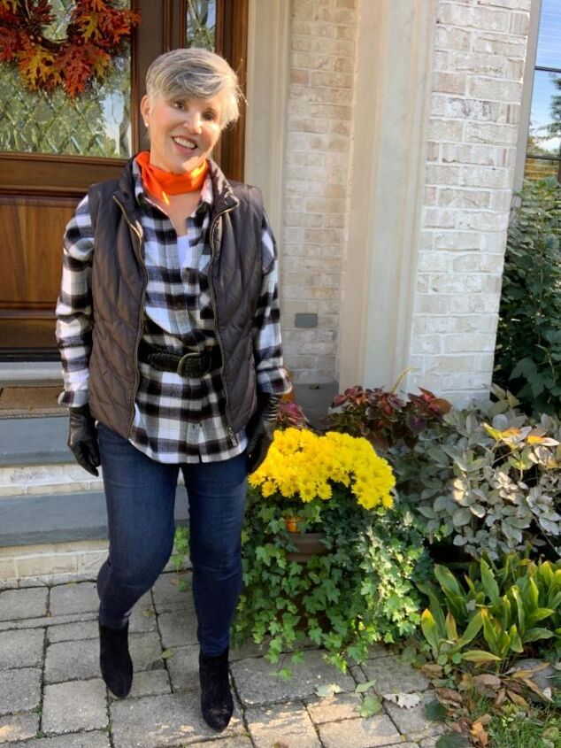 three fall family photo outfits ideas, I am modeling black and white in a big shirt with a black puffer vest as well as a black suede belt My jeans are dark wash and my booties are black suede