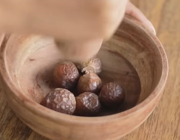 super easy soapnut shampoo recipe for thick and healthy hair, Crushing soapnuts