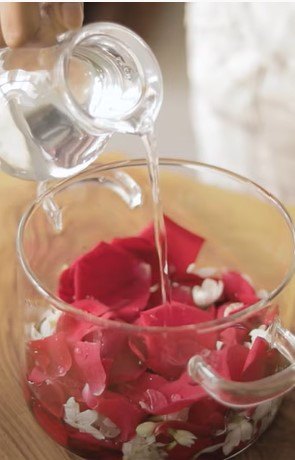 how to make jasmine and rose water for super shiny hair, Adding petals to a pot with water