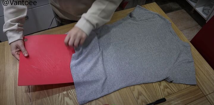 how to create an awesome diy fossil t shirt, Putting a chopping board inside the t shirt