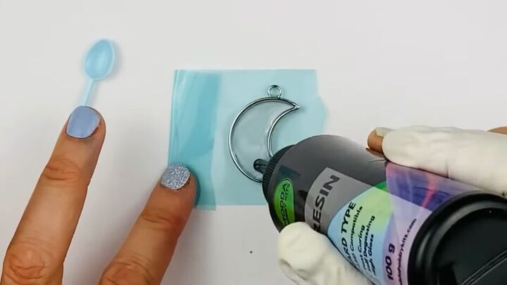 how to create a gorgeous resin moon charm using regular dish soap, Pouring resin into the charm