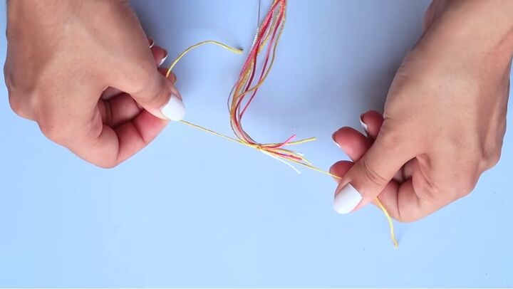 how to make cute and super easy pura vida bracelets, Tying a knot around the cords