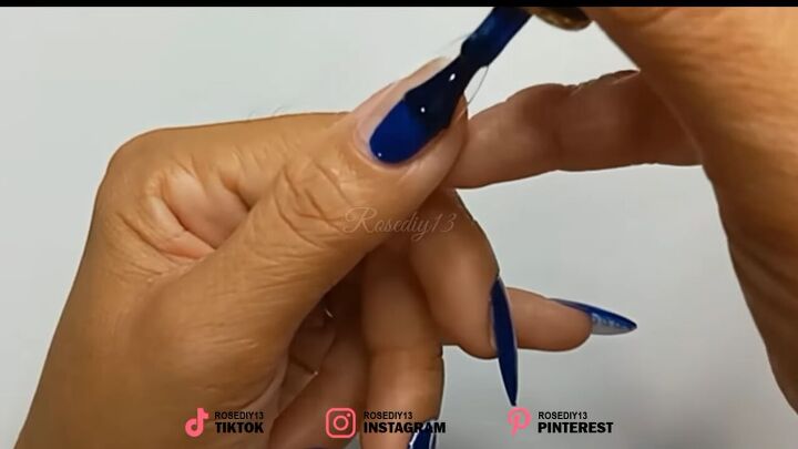 how to diy these trendy and super easy blue swirl nails, Painting thumb