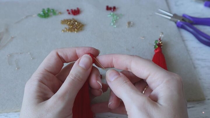 how to create a pair of gorgeous christmas earrings, Placing the tassel on the eye pin
