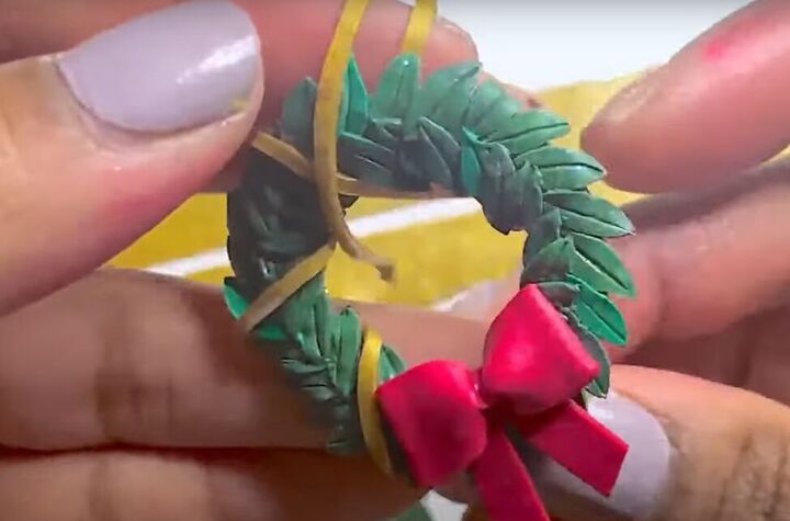 how to make super cute polymer clay christmas wreath earrings, Adding the ribbon to wreath