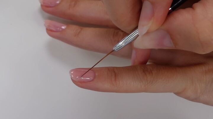save a fortune with this diy gel nails tutorial, Pulling polish with striping brush