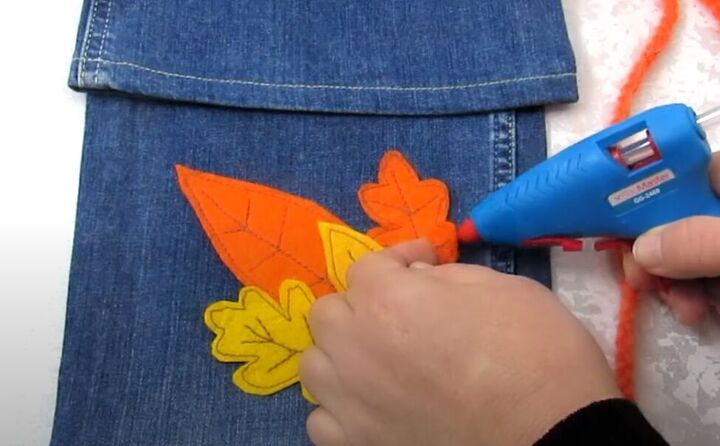 how to diy a fun crossbody bag from old jeans, Attaching decorative appliques