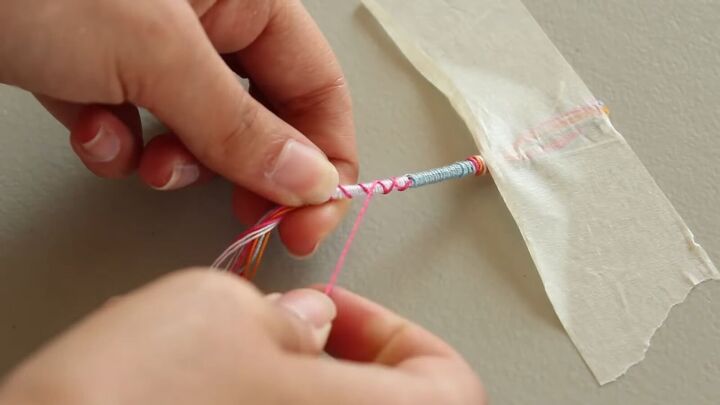 how to diy a super cute and easy wrap friendship bracelet, Criss crossing strings