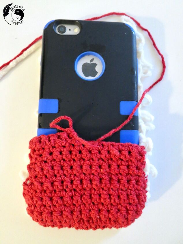 crochet phone pouch santa inspired, cell phone in crochet pouch with one third of red yarn complete